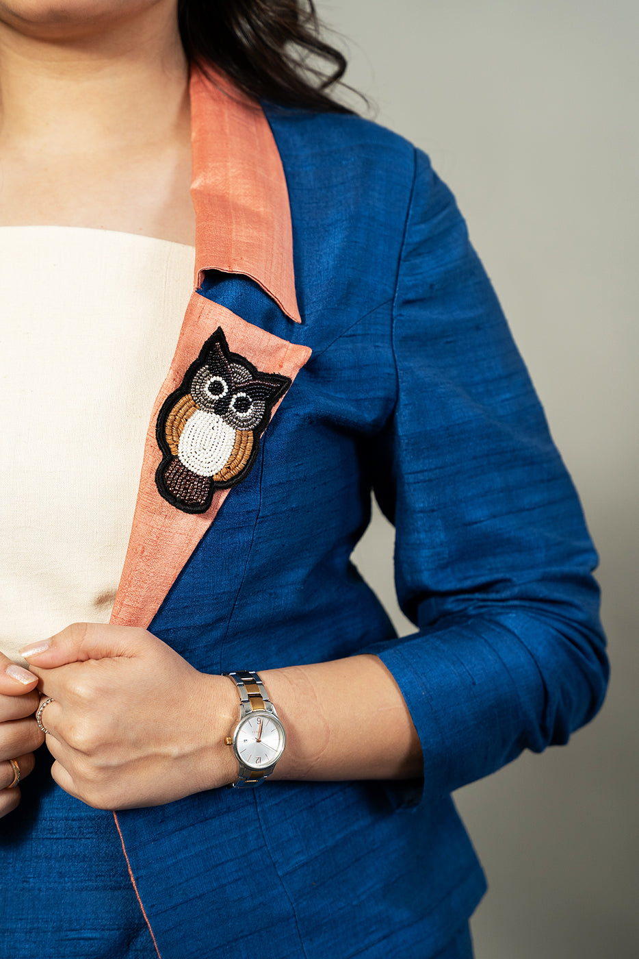 Open blazer with owl brooch