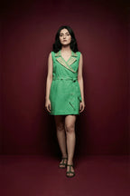Woman wearing a green dress against a red background